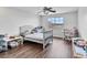 Cozy bedroom with natural light, a ceiling fan, and wood floors provides a comfortable living space at 6639 Tranquil Seas Ct, Las Vegas, NV 89139
