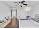 Bright bedroom with hardwood floors, ceiling fan, and ample space provides a versatile living area at 6639 Tranquil Seas Ct, Las Vegas, NV 89139