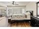 Comfortable bedroom features hardwood floors, ceiling fan, closet and neutral paint at 6639 Tranquil Seas Ct, Las Vegas, NV 89139
