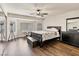 Relaxing bedroom features hardwood floors, ceiling fan, neutral paint and bay window at 6639 Tranquil Seas Ct, Las Vegas, NV 89139