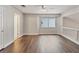 Bright bonus room featuring beautiful hardwood floors, a ceiling fan, and a large window for natural light at 6639 Tranquil Seas Ct, Las Vegas, NV 89139