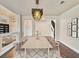 Dining area with modern chandelier, hardwood floors, and seating for six at 6639 Tranquil Seas Ct, Las Vegas, NV 89139