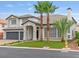 Charming two-story home featuring a three-car garage, lush lawn, and desert landscaping at 6639 Tranquil Seas Ct, Las Vegas, NV 89139