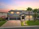 Beautiful two-story home boasting a brick driveway, well-manicured lawn, and lovely palm trees at 6639 Tranquil Seas Ct, Las Vegas, NV 89139