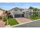 Charming two-story home featuring a three-car garage, brick driveway, and lush front lawn at 6639 Tranquil Seas Ct, Las Vegas, NV 89139
