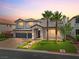 Lovely two-story home featuring a brick driveway, three-car garage, and desert landscaping at 6639 Tranquil Seas Ct, Las Vegas, NV 89139