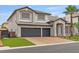 Gorgeous two-story home with three-car garage, brick driveway, desert landscaping, and gray accents at 6639 Tranquil Seas Ct, Las Vegas, NV 89139