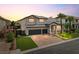 Gorgeous two-story home showcasing a three-car garage, brick driveway, and lush front lawn at 6639 Tranquil Seas Ct, Las Vegas, NV 89139