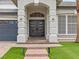 Elegant double front doors with modern design, flanked by stately columns and manicured landscaping at 6639 Tranquil Seas Ct, Las Vegas, NV 89139