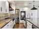 Modern kitchen with stainless steel appliances, white cabinetry, and stylish backsplash at 6639 Tranquil Seas Ct, Las Vegas, NV 89139