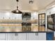 Island kitchen features stainless steel appliances, dual ovens, and modern lighting at 6639 Tranquil Seas Ct, Las Vegas, NV 89139