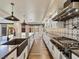 Chef's kitchen with oversized island, stainless appliances, and custom backsplash at 6639 Tranquil Seas Ct, Las Vegas, NV 89139