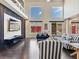 Modern living room showcases a high ceiling, multiple windows, and stylish striped sofas at 6639 Tranquil Seas Ct, Las Vegas, NV 89139