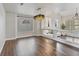 Open-concept dining and living space with wood floors, designer lighting, and neutral decor at 6639 Tranquil Seas Ct, Las Vegas, NV 89139