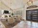 Open-concept living room featuring a fireplace, high ceilings, neutral tones, and contemporary furnishings at 6639 Tranquil Seas Ct, Las Vegas, NV 89139