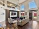Sunlit living room featuring floor to ceiling windows, hardwood floors, and stylish furnishings at 6639 Tranquil Seas Ct, Las Vegas, NV 89139
