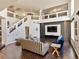 Bright open-plan living room featuring hardwood floors, vaulted ceilings, and comfortable contemporary furnishings at 6639 Tranquil Seas Ct, Las Vegas, NV 89139