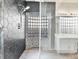 Modern shower featuring dark hexagon tiles, glass divider, and contemporary fixtures at 6639 Tranquil Seas Ct, Las Vegas, NV 89139