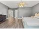 Spacious main bedroom with wood-look floors, ceiling fan, and ensuite bath at 6639 Tranquil Seas Ct, Las Vegas, NV 89139