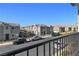 View from the balcony overlooking a street with parked cars and similar-style homes at 6952 Crescent Gold St, North Las Vegas, NV 89086
