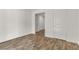 Open-concept bedroom offering plank floors, a door, and natural light at 6952 Crescent Gold St, North Las Vegas, NV 89086
