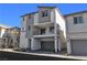Contemporary three-story townhome with a private balcony and a two-car garage at 6952 Crescent Gold St, North Las Vegas, NV 89086