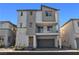 Inviting three-story townhome featuring a balcony, a two-car garage, and modern design at 6952 Crescent Gold St, North Las Vegas, NV 89086