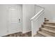 Well-lit foyer featuring the staircase and an entry door, creating a welcoming atmosphere at 6952 Crescent Gold St, North Las Vegas, NV 89086