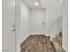 Bright and airy foyer with hardwood floors, access to the staircase, and a coat closet at 6952 Crescent Gold St, North Las Vegas, NV 89086