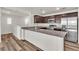 Bright kitchen with granite counters, stainless appliances, island and wood-look flooring at 6952 Crescent Gold St, North Las Vegas, NV 89086