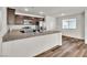 Modern kitchen features stainless steel appliances, granite countertops, and an island with a sink at 6952 Crescent Gold St, North Las Vegas, NV 89086
