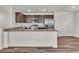 Modern kitchen boasts stainless steel appliances, granite countertops, and wood-look flooring at 6952 Crescent Gold St, North Las Vegas, NV 89086