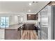 Open-concept kitchen with stainless appliances, granite counters, and slider to exterior at 6952 Crescent Gold St, North Las Vegas, NV 89086
