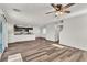 Open-concept living room featuring sleek wood floors that flow into the kitchen at 6952 Crescent Gold St, North Las Vegas, NV 89086