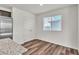 Bright room boasts wood-look flooring, natural light, and a pair of double doors at 6952 Crescent Gold St, North Las Vegas, NV 89086