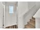 The stairway leads up, with a handrail and natural light from the window at 6952 Crescent Gold St, North Las Vegas, NV 89086