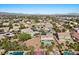 Expansive aerial view showcasing a residential neighborhood with pools, palm trees, and mountain views at 7221 Harlow St, Las Vegas, NV 89131