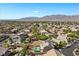 Panoramic aerial showcasing a neighborhood with desert landscaping, swimming pools, and mountain backdrop at 7221 Harlow St, Las Vegas, NV 89131