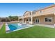 Gorgeous backyard with a pool, spa, covered patio and lush green lawn at 7221 Harlow St, Las Vegas, NV 89131