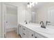 Bathroom boasting dual sinks, white cabinets, new faucets, and tile floors at 7221 Harlow St, Las Vegas, NV 89131