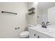 Bathroom with new vanity, updated lighting and mirror, with toilet and open shelves at 7221 Harlow St, Las Vegas, NV 89131