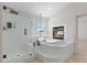Bright bathroom features a glass shower, soaking tub and a fireplace at 7221 Harlow St, Las Vegas, NV 89131