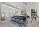 Bright bedroom with a ceiling fan, French doors and a blue accent rug at 7221 Harlow St, Las Vegas, NV 89131