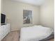 Bedroom featuring carpet floor, a window, and dresser with TV at 7221 Harlow St, Las Vegas, NV 89131