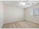 This bedroom has carpet, white walls, a ceiling fan, and a window at 7221 Harlow St, Las Vegas, NV 89131