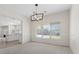 Light-filled dining room with chandelier and a view of the fenced backyard and swimming pool at 7221 Harlow St, Las Vegas, NV 89131