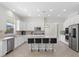 Modern kitchen featuring stainless steel appliances, a kitchen island, and sleek white cabinets at 7221 Harlow St, Las Vegas, NV 89131