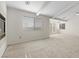 Spacious living room features large windows, fireplace, neutral carpet, and access to the outdoor patio at 7221 Harlow St, Las Vegas, NV 89131