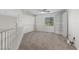 Upstairs loft features carpet, a window with blinds, and a built-in bookshelf at 7221 Harlow St, Las Vegas, NV 89131