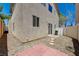 Private backyard featuring gravel, pavers, stone steps, sliding glass door and stucco walls at 7249 Linaria Rd, Las Vegas, NV 89113